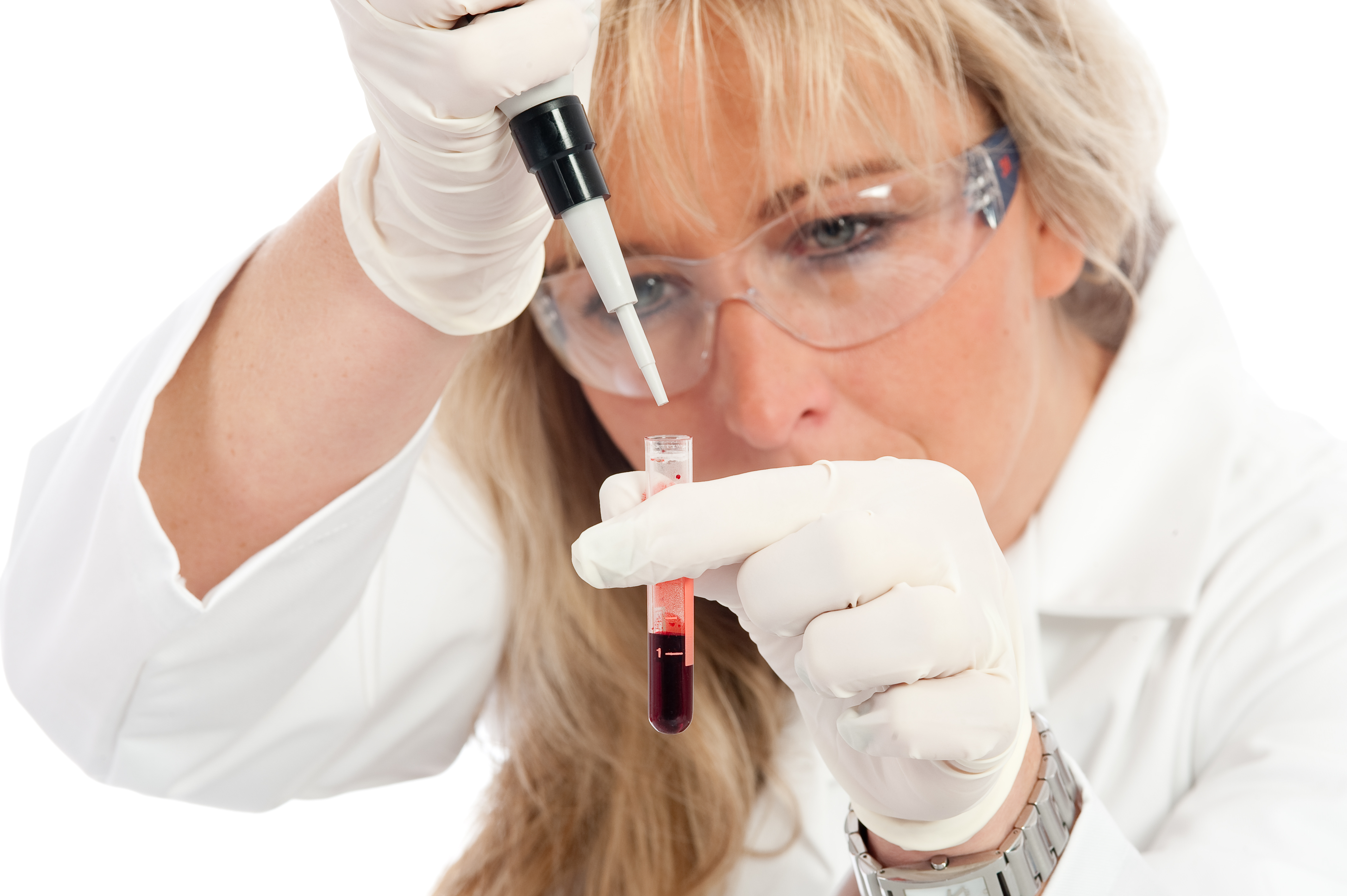 Scientist looking closely at a blood sample in a test tube